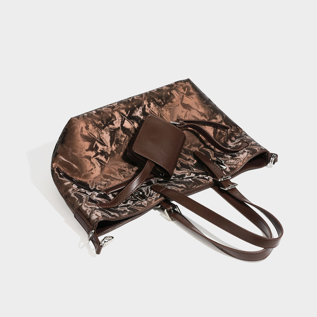Glossy crinkled metallic-finish tote bag in brown with smooth leather-look top handles, silver-tone hardware, and attached