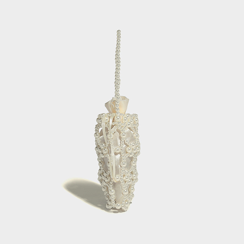 Small pearl-beaded lattice drawstring bucket bag with beaded shoulder strap and ribbon closure, detail view 18