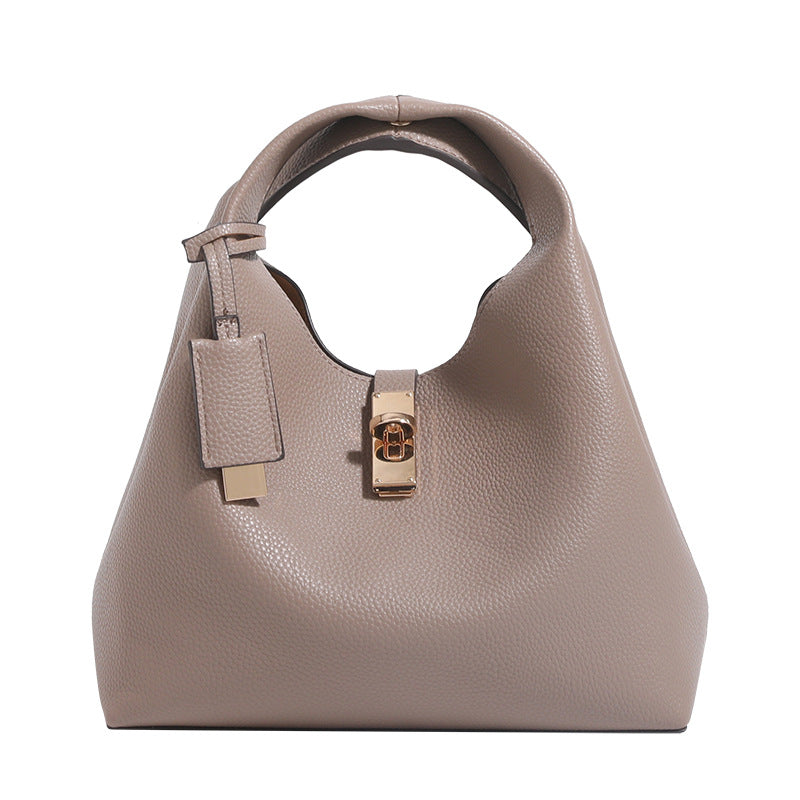 Structured pebbled leather-look bucket tote with gold-tone turn-lock hardware and looped top handle, detail view 5