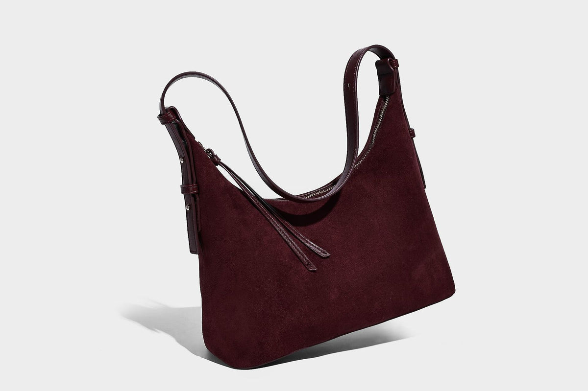 Dark brown suede-look hobo shoulder bag with top zip closure, adjustable strap, and small detachable mini pouch, detail view
