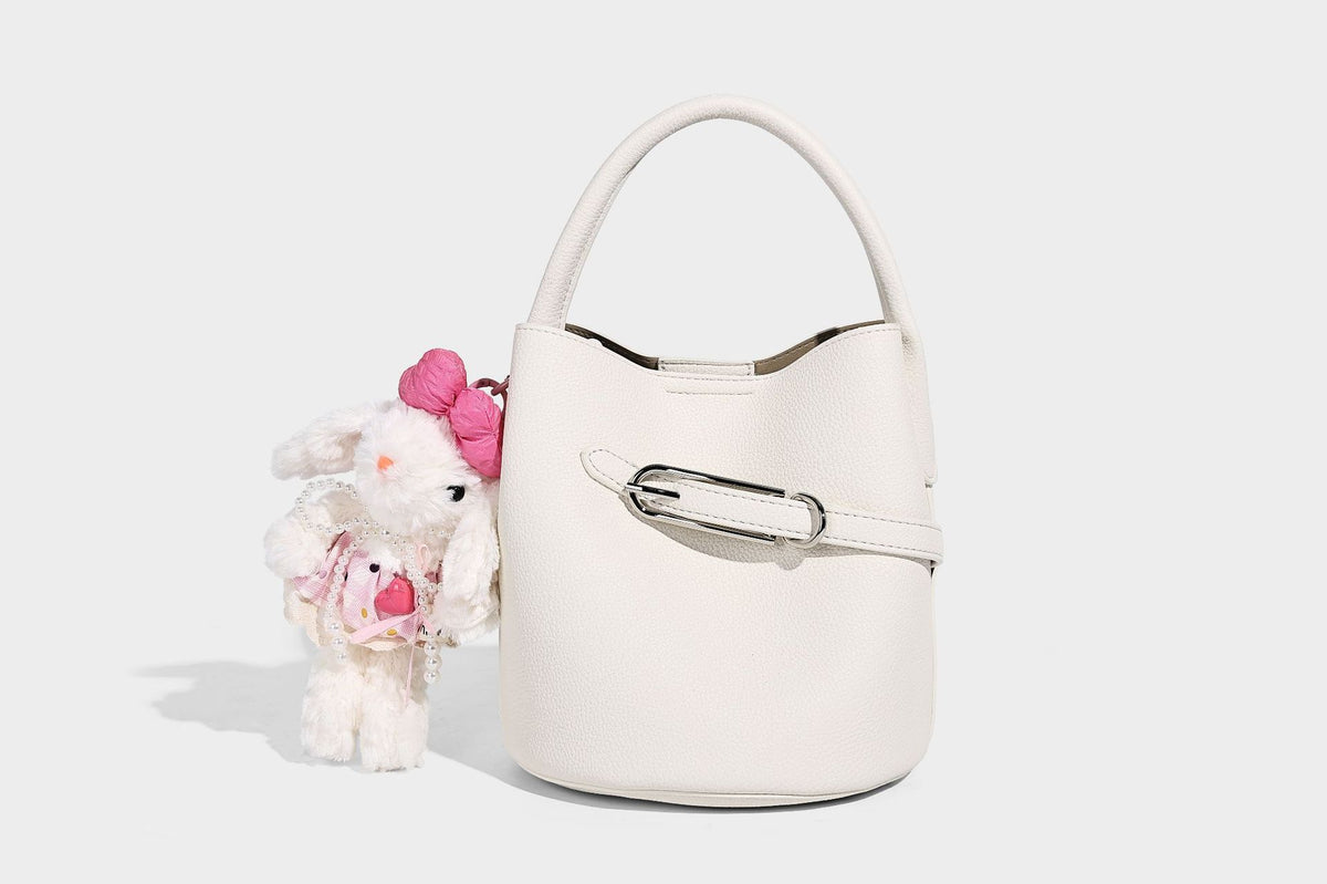 Mini pebbled leather-look bucket bag with front buckle strap, silver-tone hardware, top handle, and detachable shoulder
