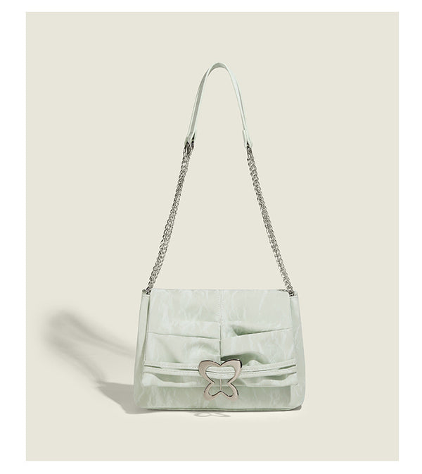 Structured rectangular chain shoulder bag with silver butterfly clasp and glossy crinkled finish, detail view 10