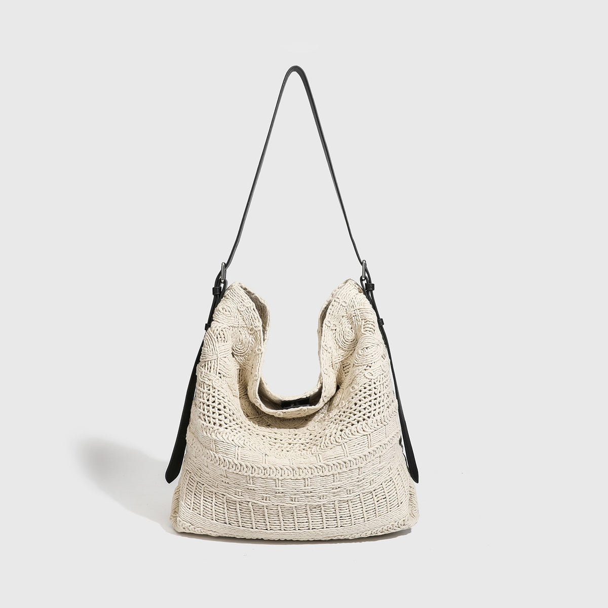 Cream woven rope-cord hobo bag with black adjustable leather-look strap and matching cream drawstring pouch, detail view 6