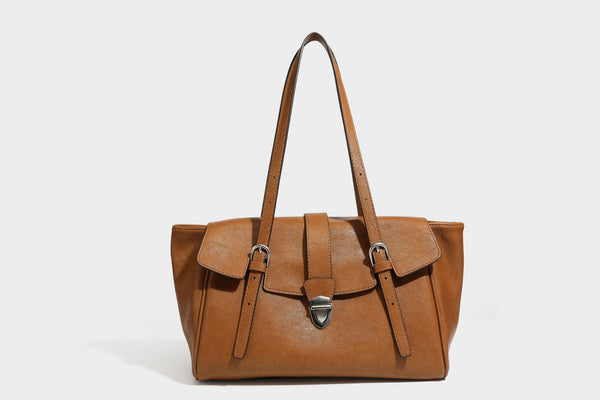 Large structured vintage-style tote bag with flap-front turn-lock closure, twin buckle straps, and double shoulder handles