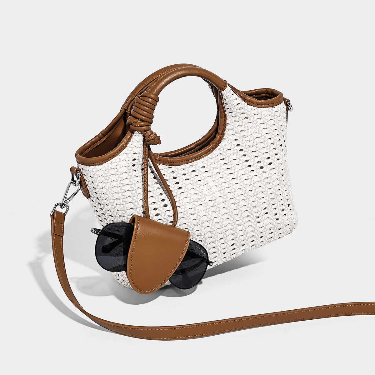 Small structured woven tote crossbody bag with ring top handle, leather-look brown trim, front patch pocket, and detachable