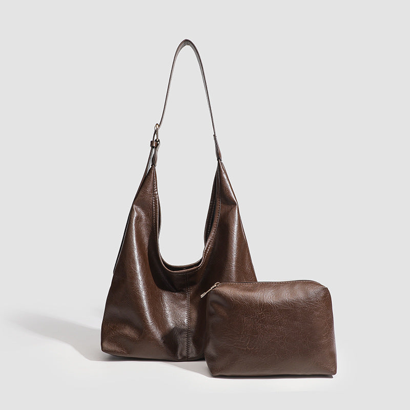 Large slouchy hobo shoulder bag in smooth leather-look finish with adjustable strap and gold-tone hardware, detail view 3