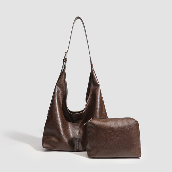 Large slouchy hobo shoulder bag in smooth leather-look finish with adjustable strap and gold-tone hardware, detail view 3