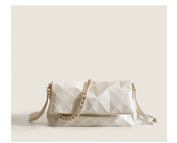 Cream white rectangular flap shoulder bag with geometric faceted surface and chunky tone-on-tone chain strap with gold-tone