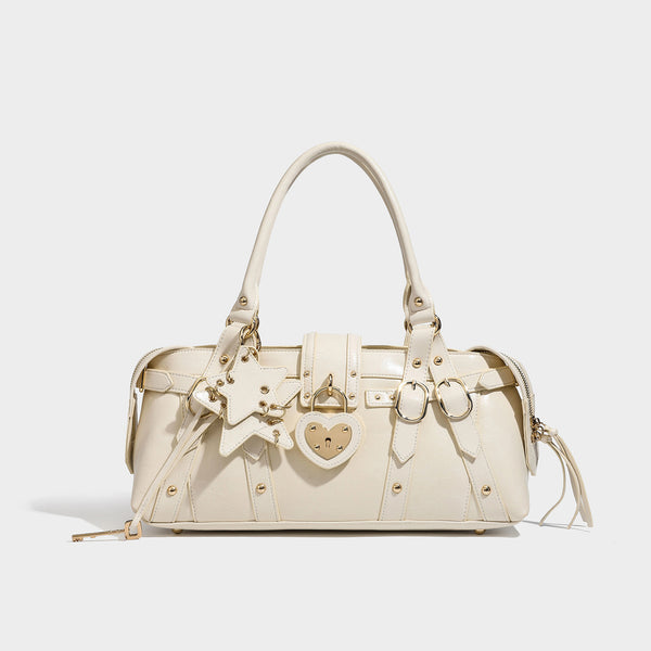 Dark brown glossy crinkled leather-look barrel bag with gold heart lock, dome studs, star charm, dual top handles and, detail