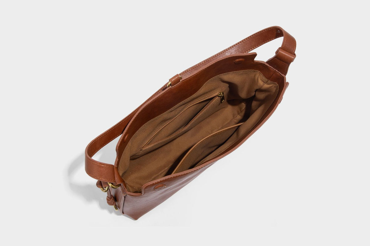 Slouchy brown leather-look shoulder bag with knotted drawcord tie closure, gold-tone ring hardware, and long adjustable