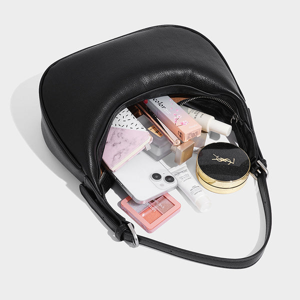 Crescent half-moon shoulder bag in pebbled leather-look finish with adjustable strap and silver-tone hardware, detail view 4