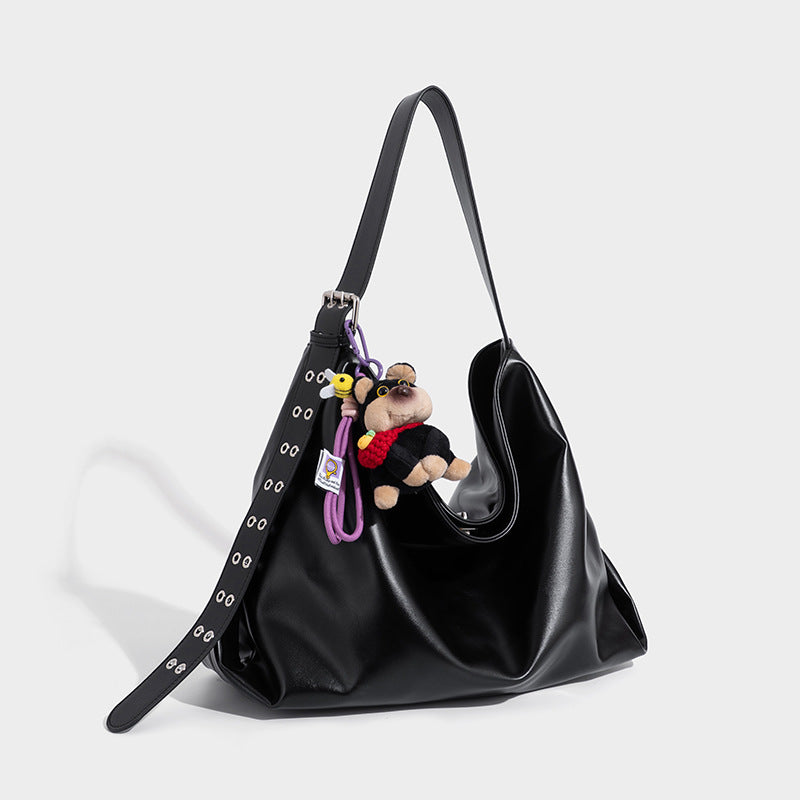 Large black glossy leather-look slouchy hobo shoulder bag with eyelet-studded strap, silver-tone hardware, and detachable