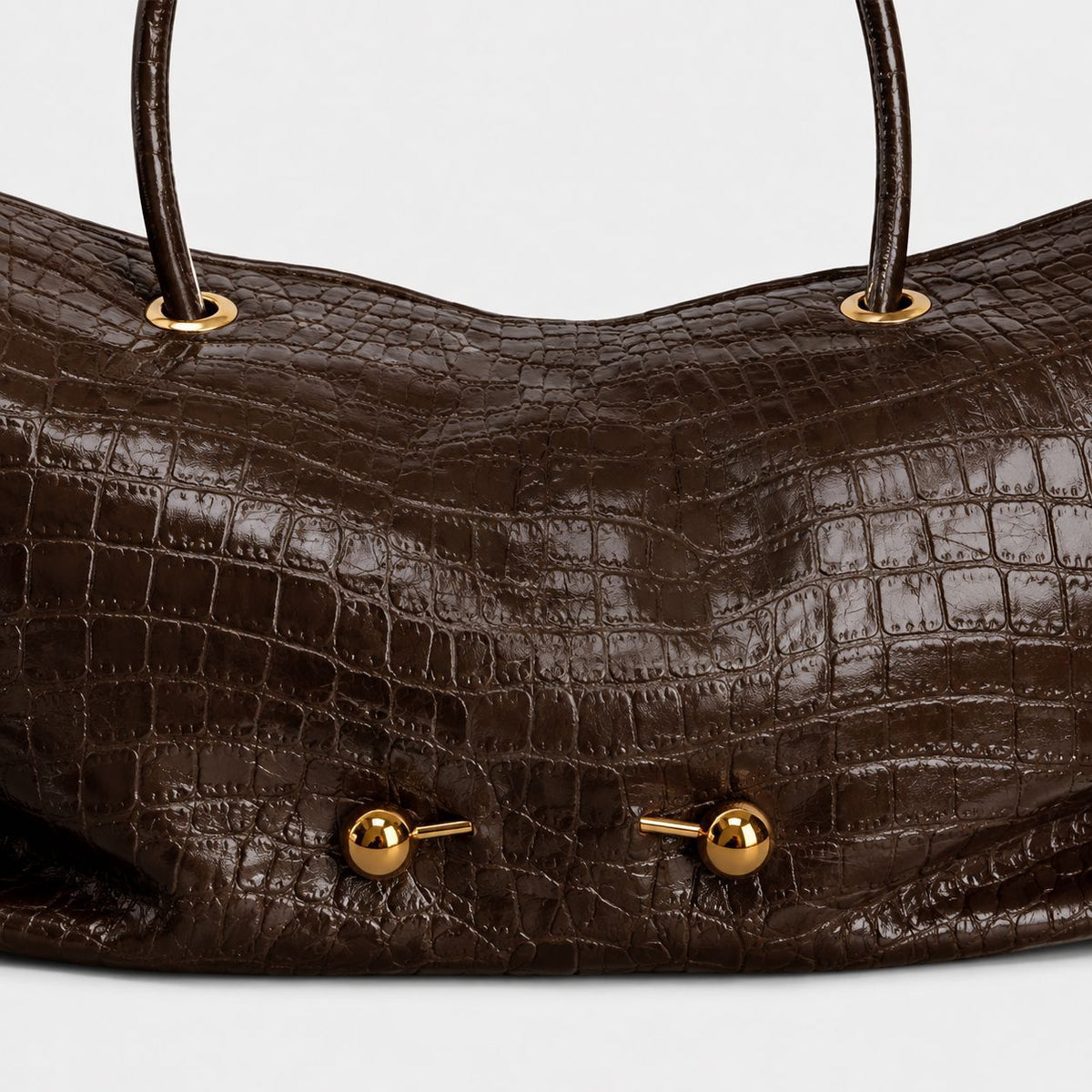 Wide embossed-texture shoulder tote bag with single loop handle and gold-tone toggle hardware, detail view 24