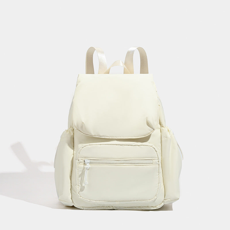 Soft matte nylon flap backpack with front zip pocket and side drawcord pockets, detail view 6