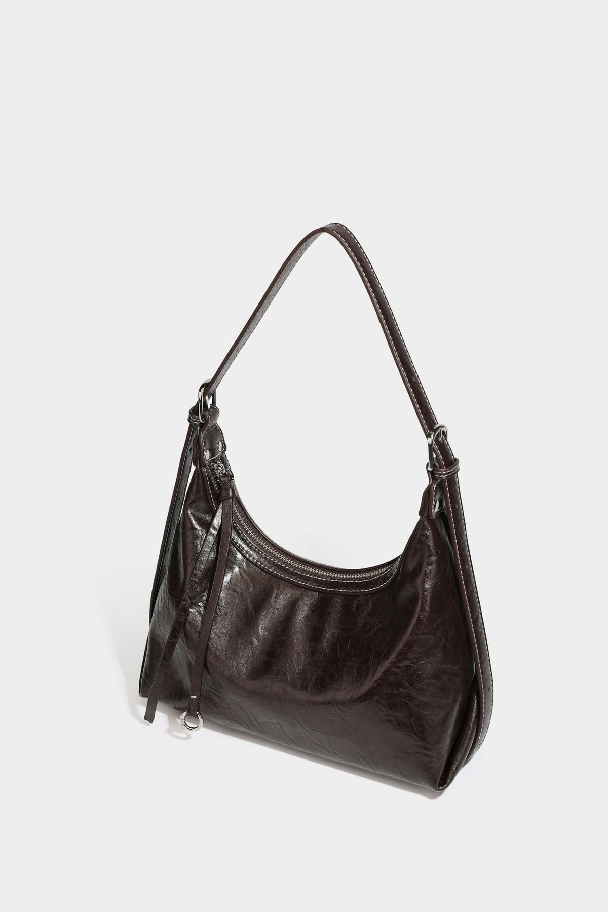 Slouchy hobo shoulder bag in glossy crinkled leather-look finish with zip-top closure and silver-tone ring hardware, detail