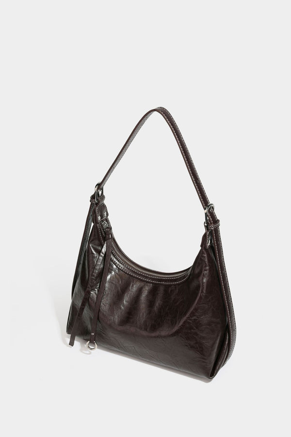 Slouchy hobo shoulder bag in glossy crinkled leather-look finish with zip-top closure and silver-tone ring hardware, detail