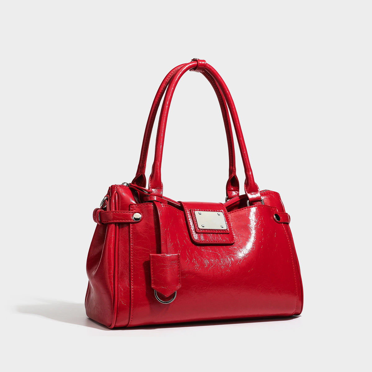Structured glossy crinkled leather-look satchel with double top handles, front metal-plaque tab, silver-tone hardware, and