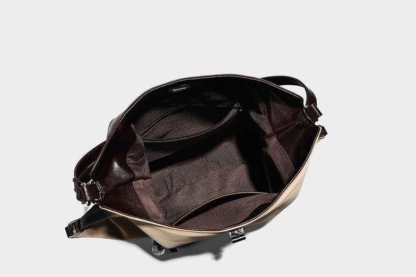 Slouchy hobo tote bag with matte leather-look finish, triangular silhouette, front zip pocket, and adjustable shoulder strap