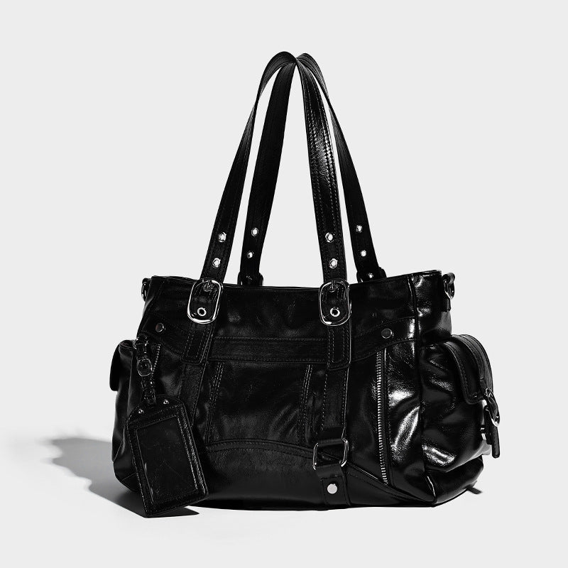 Glossy structured black tote shoulder bag with silver buckle hardware, zip pockets, dual top handles, and detachable, detail