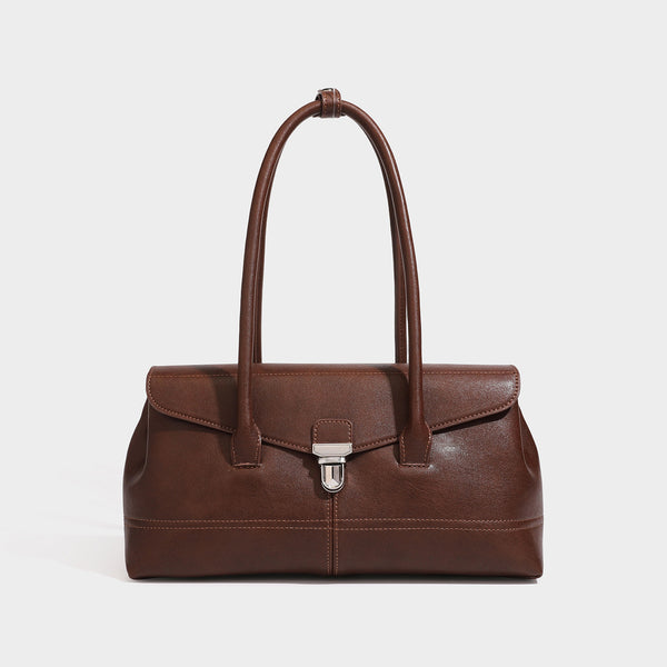 Structured rectangular satchel bag with dual rounded top handles and central metal turn-lock flap closure, detail view 3