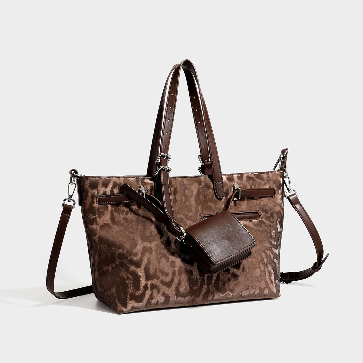 Glossy leopard-print tote bag with leather-look dark trim, dual top handles, detachable shoulder strap, and attached front