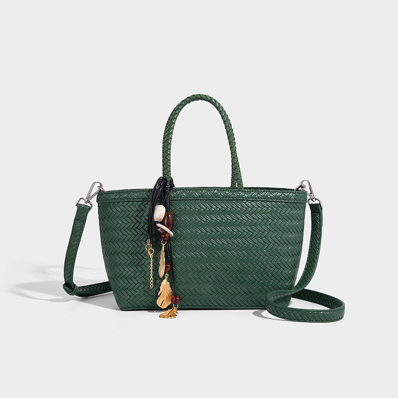 Structured chevron woven leather-look tote bag with braided top handles, gold feather charm, and adjustable shoulder strap