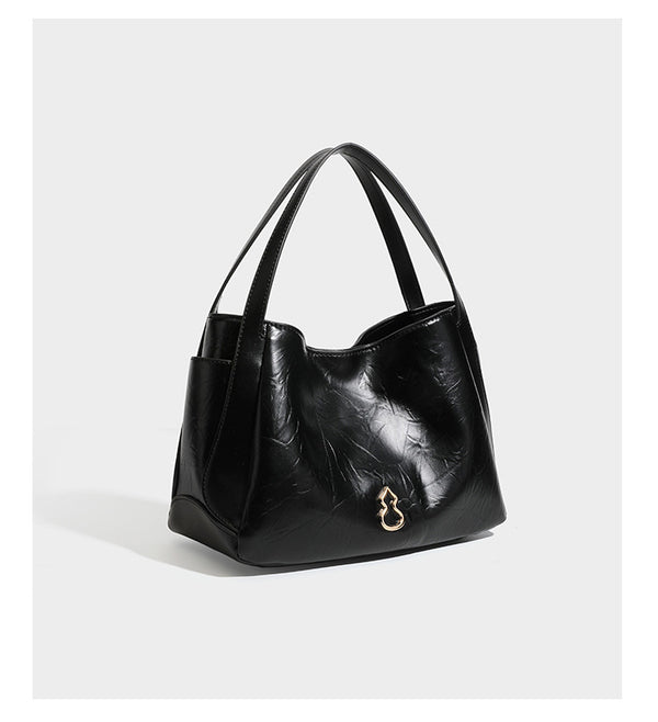 Black glossy crinkled leather-look convertible shoulder tote bag with gold gourd-shaped emblem hardware and detachable