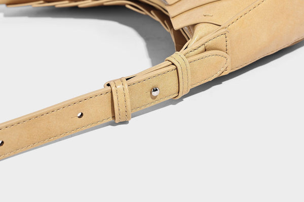 Crescent half-moon shoulder bag with vertical panel seaming, matte-satin leather-look finish, and adjustable gold-tone