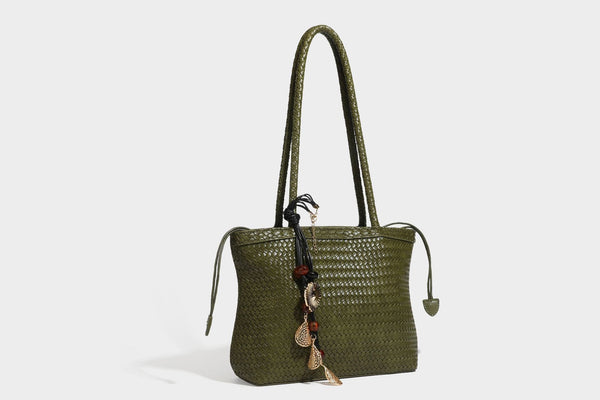 Structured woven leather-look tote bag in dark brown with long shoulder straps, side drawstring ties, and gold filigree