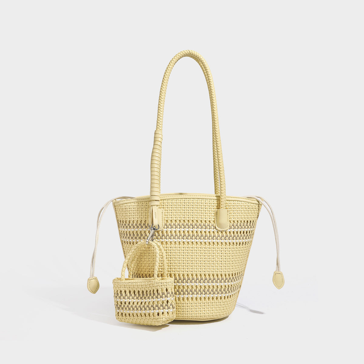 Structured woven bucket tote bag in pastel blue with braided shoulder strap, open lattice weave body, cream drawstring