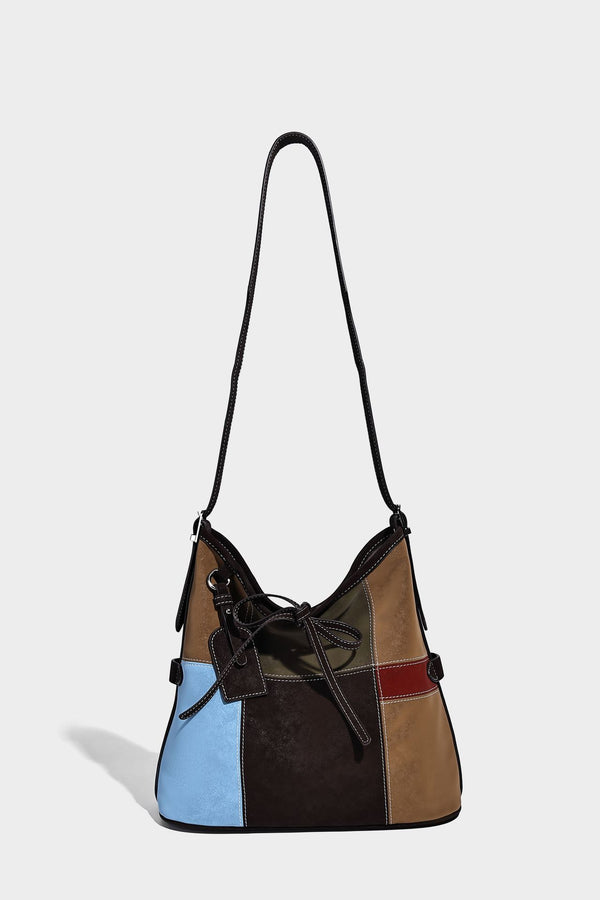 Patchwork bucket tote shoulder bag with tan, dark brown, olive, red, and sky blue color-block panels, white contrast, detail