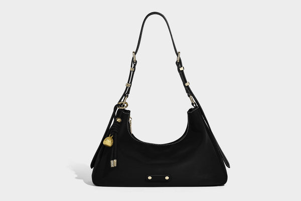 Crescent hobo shoulder bag in pebbled leather-look finish with top zipper, adjustable strap, gold-tone ring hardware, and