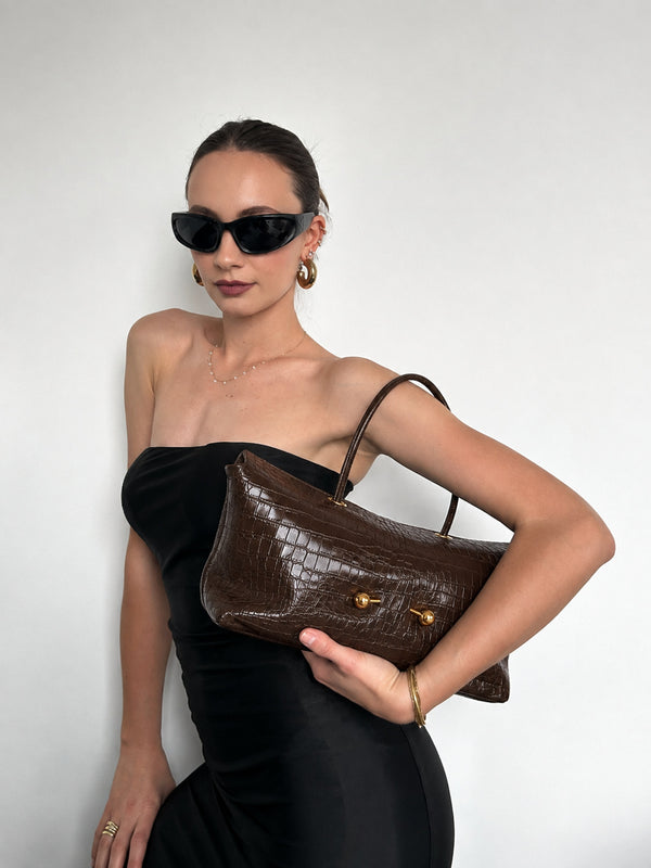 Wide embossed-texture shoulder tote bag with single loop handle and gold-tone toggle hardware, detail view 19