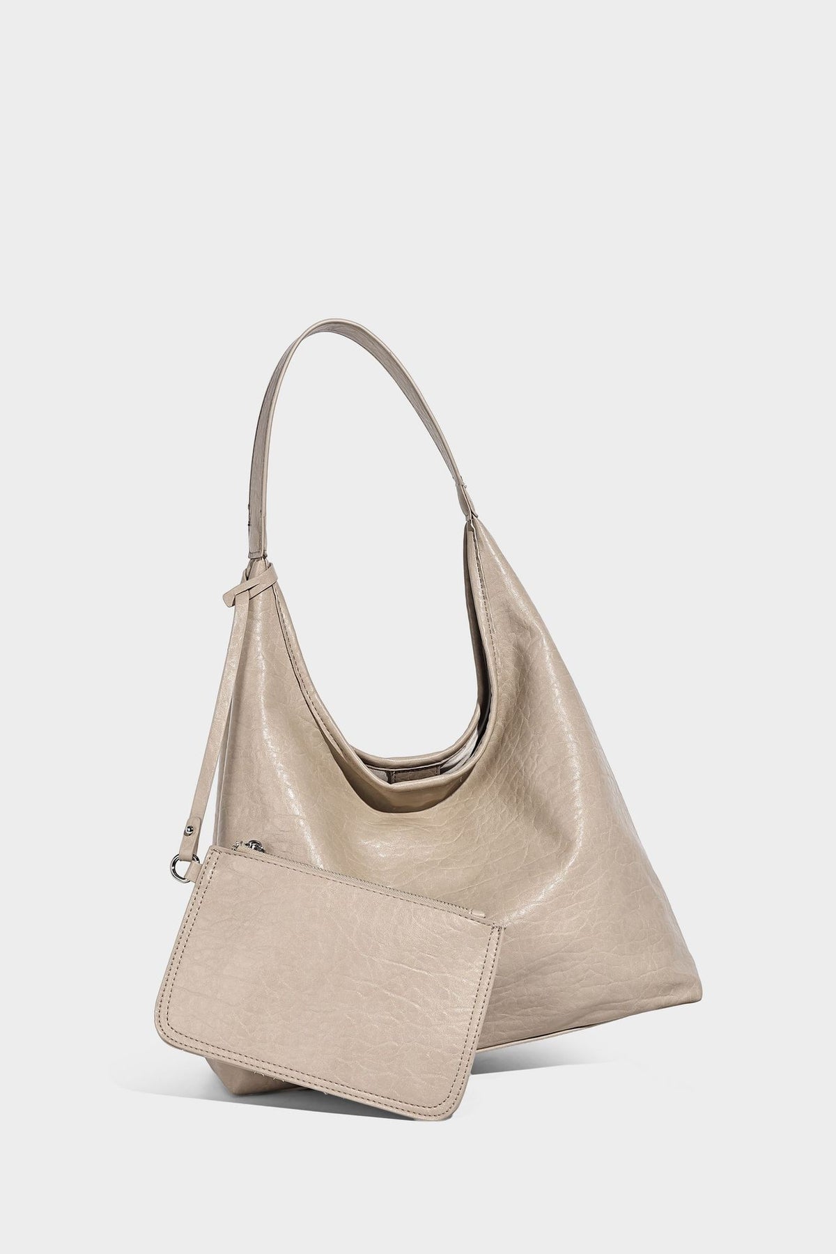 Slouchy hobo shoulder bag in pale yellow glossy pebbled leather-look finish with single shoulder strap and detachable front
