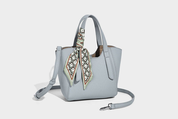 Structured pebbled leather-look tote bag with detachable scarf tie, dual top handles, and adjustable crossbody strap, detail