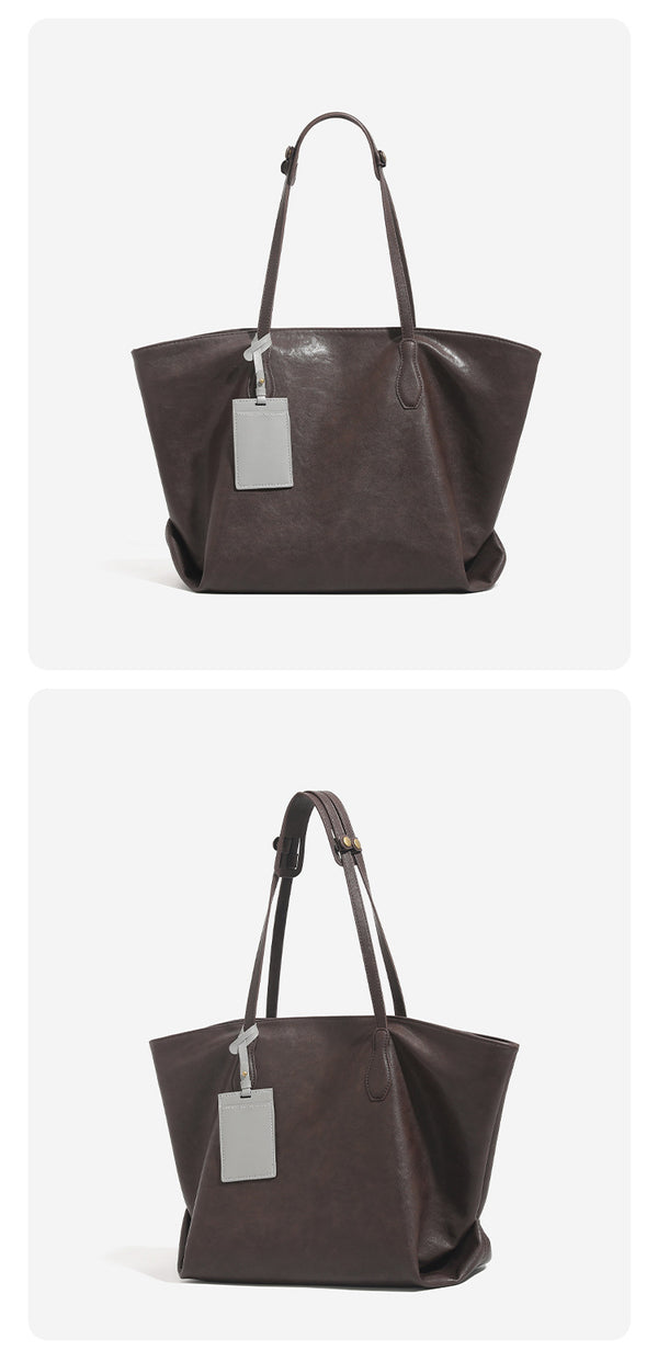 Large leather-look tote bag with trapezoid silhouette, double shoulder straps, and detachable hanging tag, detail view 12