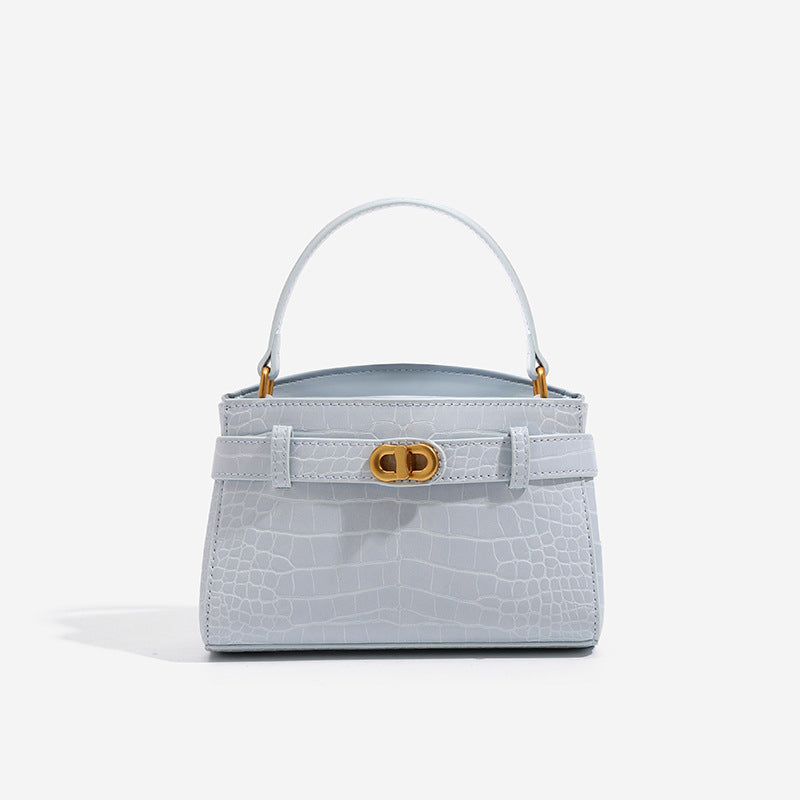 Kleine strukturierte Henkeltasche mit Krokodilprägung, goldfarbenem Drehverschluss und abnehmbarem Schulterriemen, Vorderansicht