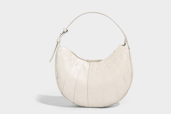 Crescent half-moon shoulder bag with vertical panel seaming, matte-satin leather-look finish, and adjustable gold-tone