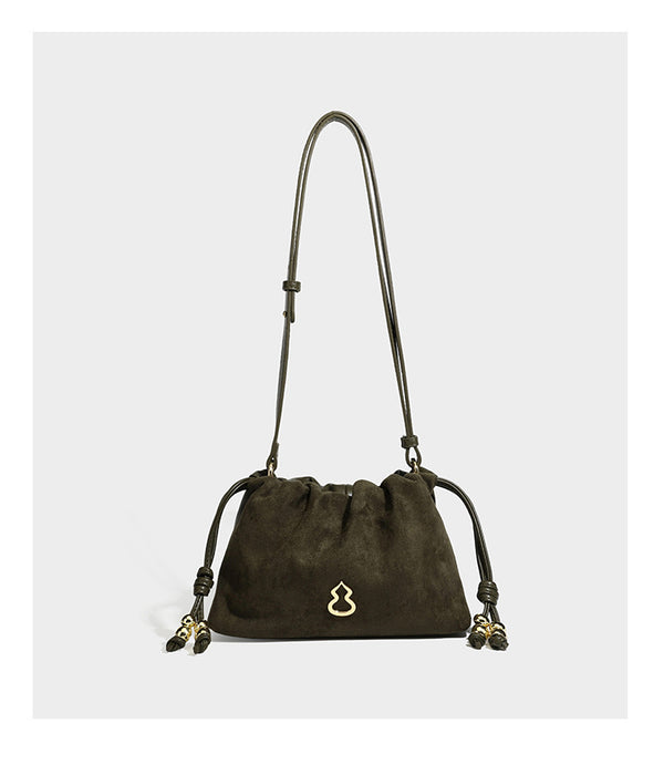 Suede-look drawstring shoulder bag in brown with smooth trim, knotted bead drawstring closure, slim adjustable strap, and