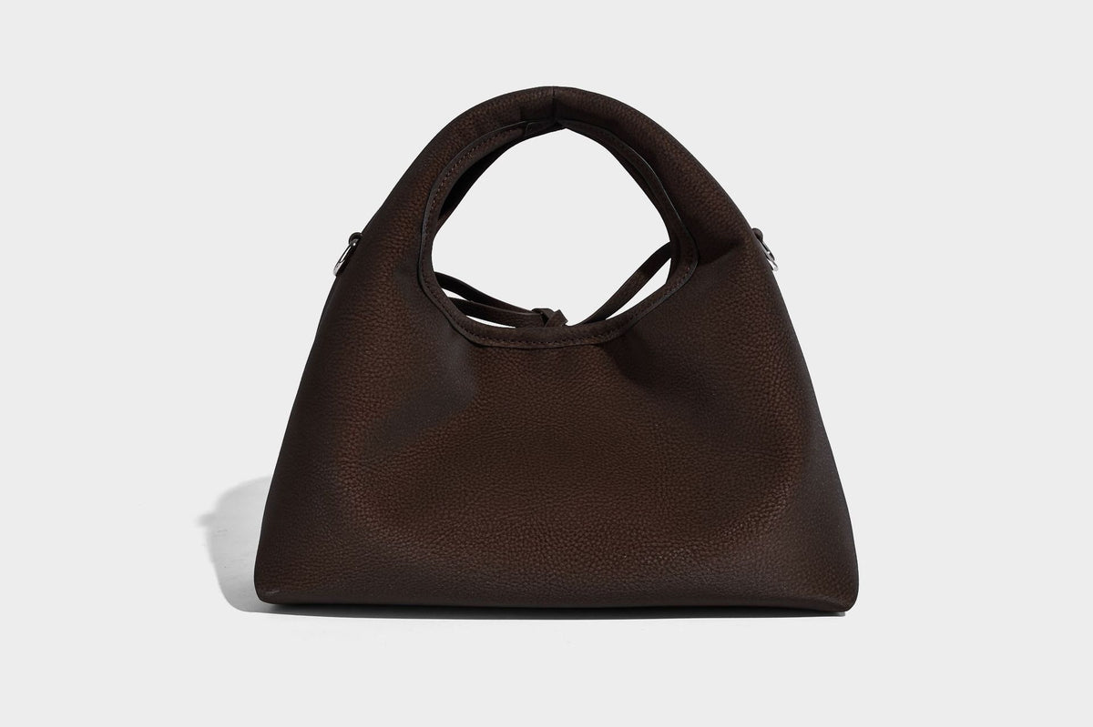 Pebbled matte trapezoid top-handle bag with drawstring bow closure, bead-tipped cords, silver-tone hardware, and detachable
