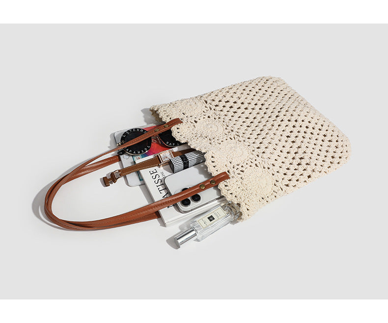 Woven crochet shoulder tote bag with scalloped floral top edge, tan leather-look straps, and antique gold rivets, detail view