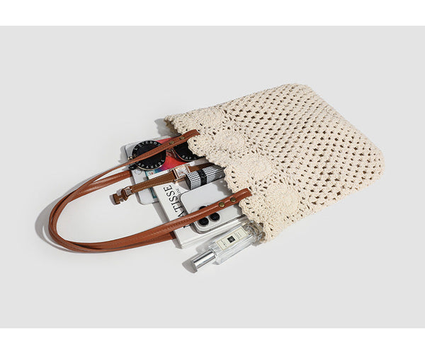 Woven crochet shoulder tote bag with scalloped floral top edge, tan leather-look straps, and antique gold rivets, detail view