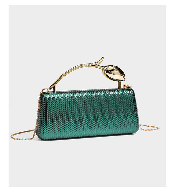 Structured rectangular metallic woven clutch bag with sculptural gold-tone leaf top handle and detachable chain strap, detail