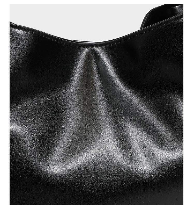 Structured glossy leather-look tote shoulder bag with dual top handles, detachable crossbody strap, side pockets, and, detail