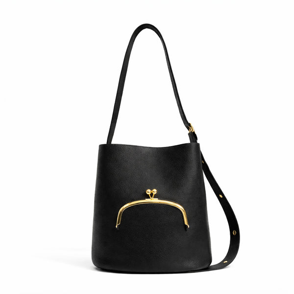 Pebbled textured bucket bag with gold-tone kiss-lock front pocket and adjustable single shoulder strap, detail view 6