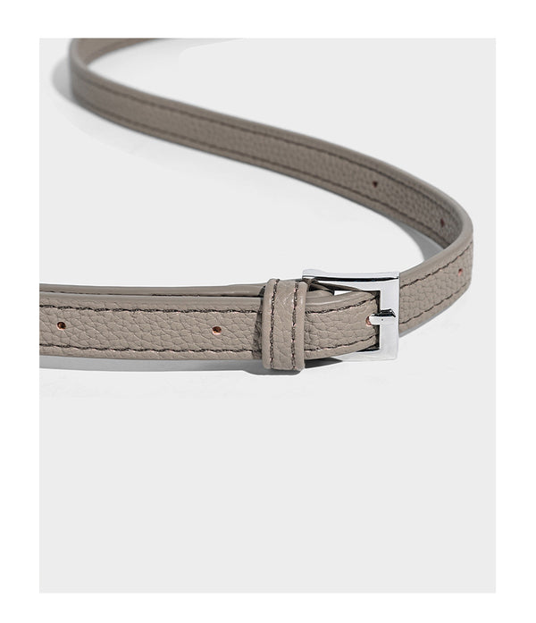 Structured pebbled leather-look tote bag with detachable scarf tie, dual top handles, and adjustable crossbody strap, detail
