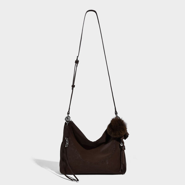 Slouchy matte-finish hobo shoulder bag with tassel cords, silver-tone hardware, and faux-fur pom charm, detail view 11