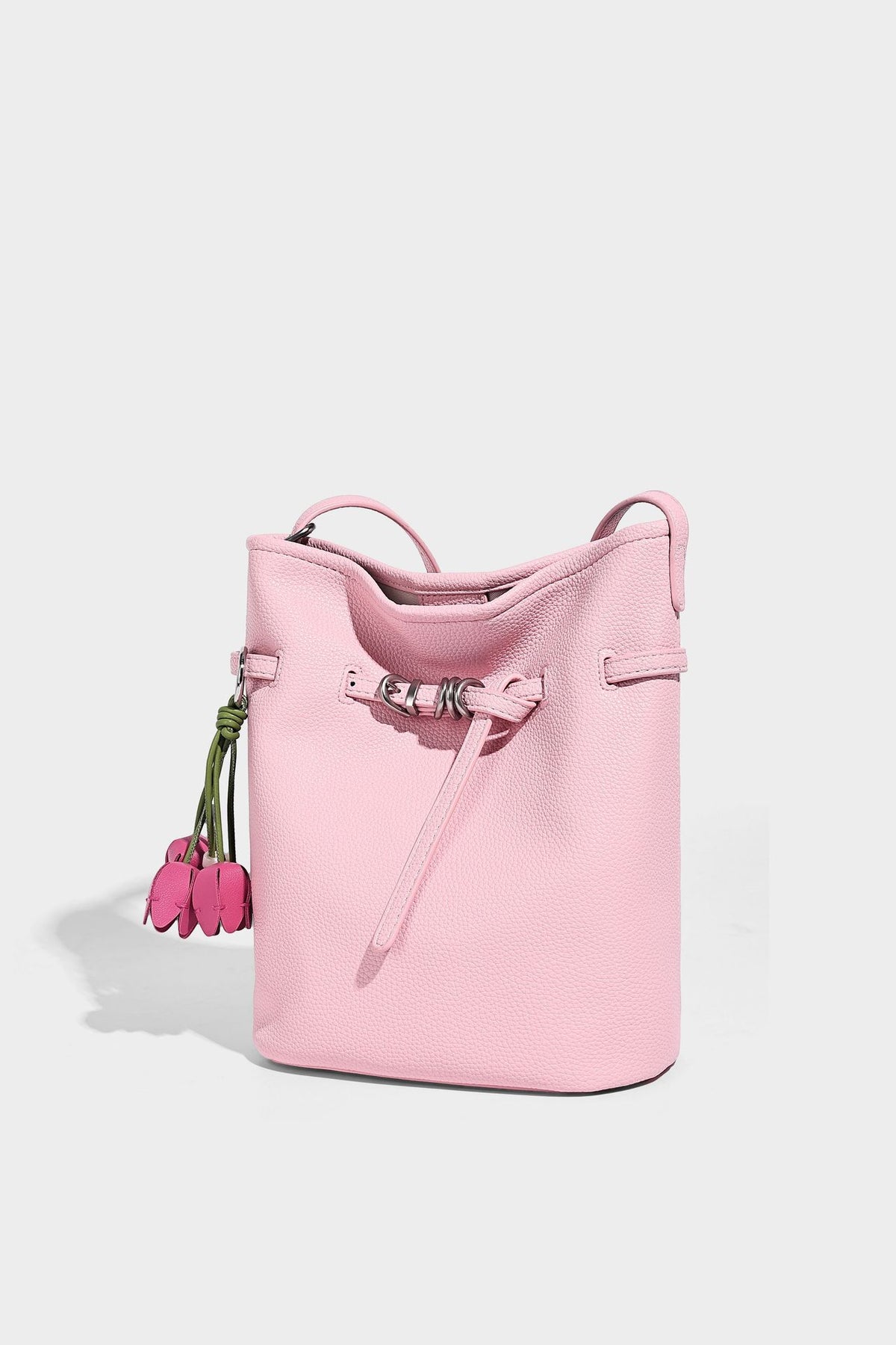 Small pebbled leather-look bucket bag with front drawstring toggle hardware and long adjustable shoulder strap, detail view