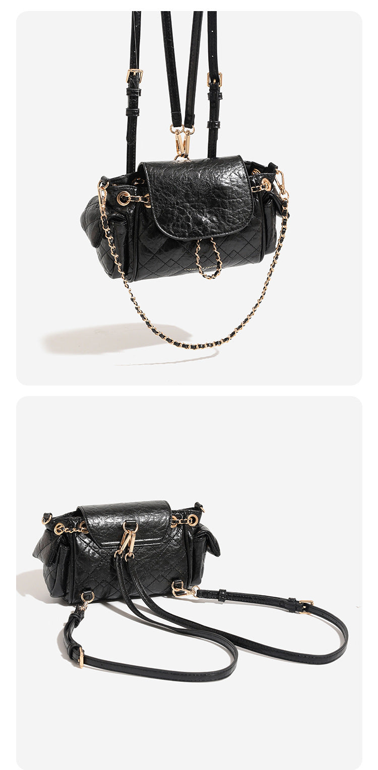 Compact quilted crinkle-finish flap bag with gold-tone chain strap and decorative chain closure detail, detail view 7