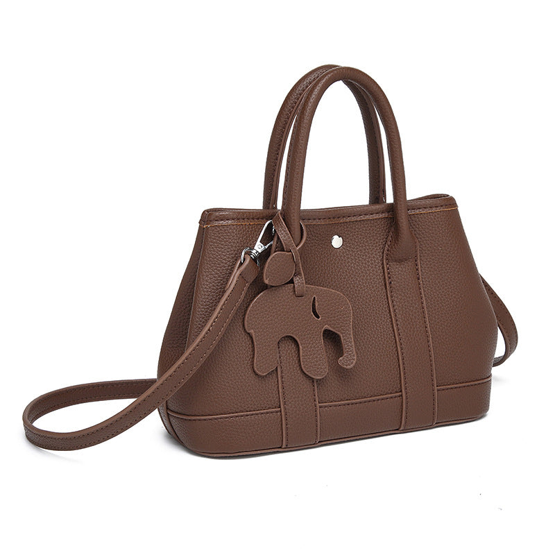 Structured pebbled leather-look top-handle tote bag with elephant charm and detachable shoulder strap, detail view 3